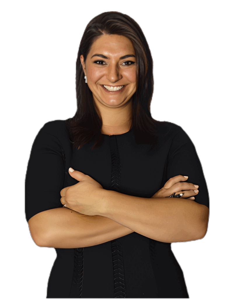 Sonia Gomez smiling confidently with arms crossed, wearing a black dress, against a bright yellow background, embodying empowerment and authenticity in entrepreneurship.